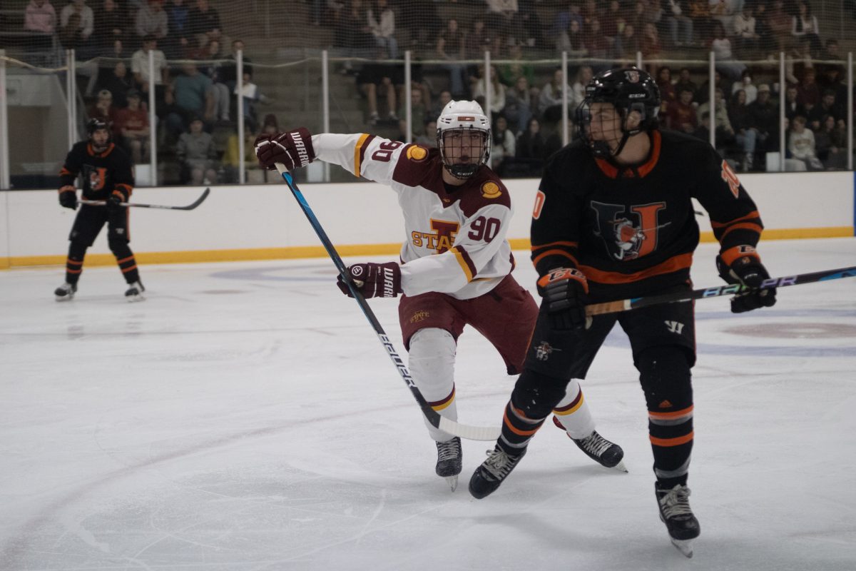 Iowa State's men's hockey club player Alex Robinson (90) rushes to the puck versus University of Jamestown men's hockey team at the ISU Ice Arena, Sept. 27, 2024. 