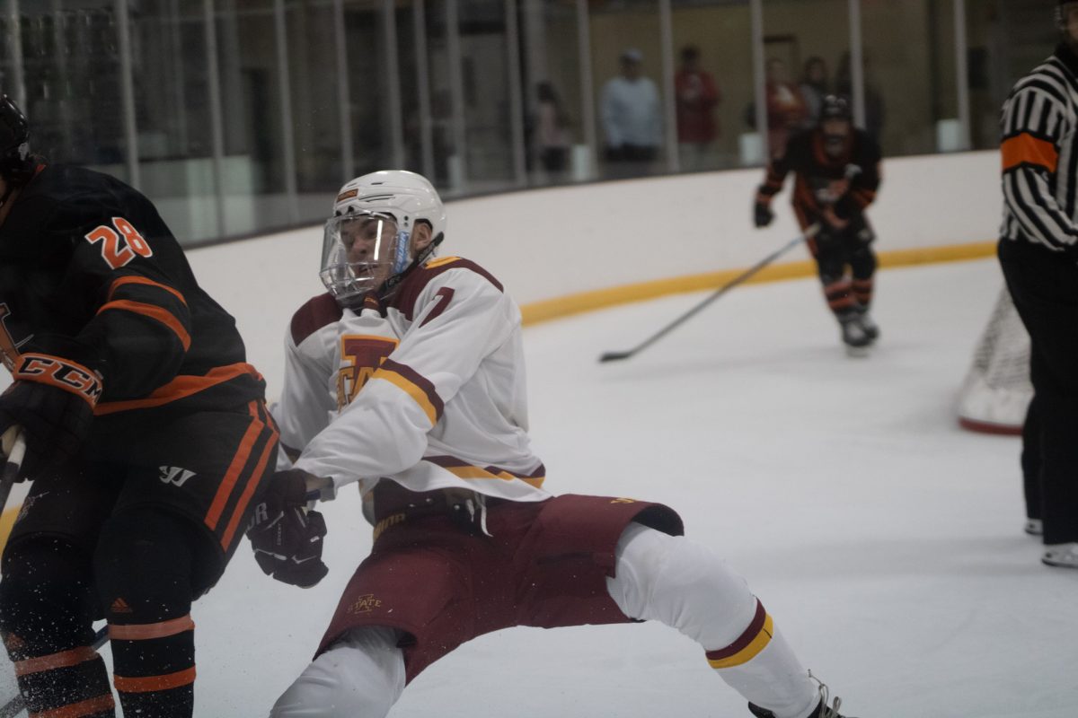 Iowa State's men's hockey club player Riley Kress (7) getting hit after playing defense versus University of Jamestown men's hockey team at the ISU Ice Arena, Sept. 27, 2024. 