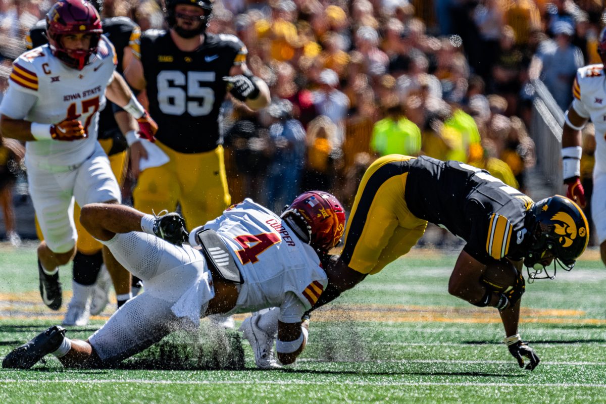 Iowa State DB Jeremiah Cooper (4) takes down a University of Iowa player during the Cy-Hawk football game on Sept. 7, 2024, Kinnick Stadium.