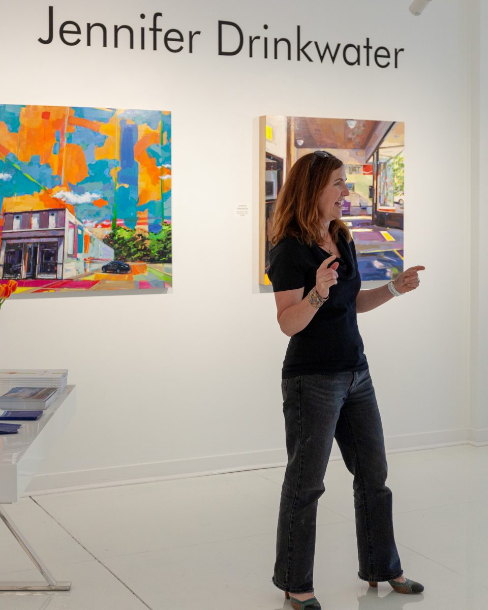 Jennifer Drinkwater standing in front of her art work.