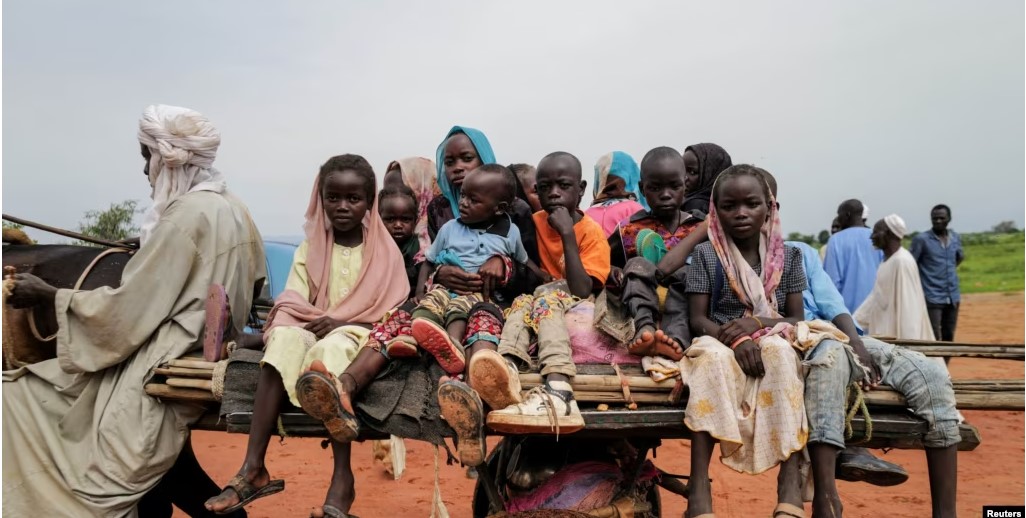 Sudanese children, who fled the conflict in Murnei in Sudan's Darfur region, ride a cart while crossing the border between Sudan and Chad in Adre, Chad, Aug. 4, 2023.