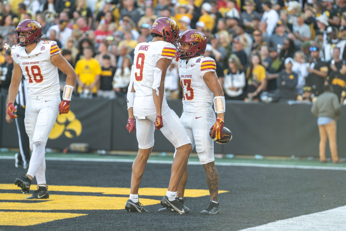 Jaylin Noel (13) and Jayden Higgins (9) bump helmets after Noel scores a long touchdown during the Cy-Hawk game against Iowa at Kinnick Stadium in Iowa City, Iowa on Sept. 7 2024. 