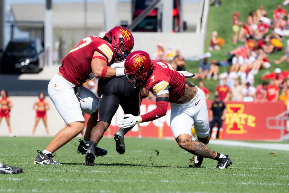 Malik Verdon (7) and Beau Freyler (17) team up to bring down an Arkansas State runner at Jack Trice Stadium on Sept. 21, 2024.