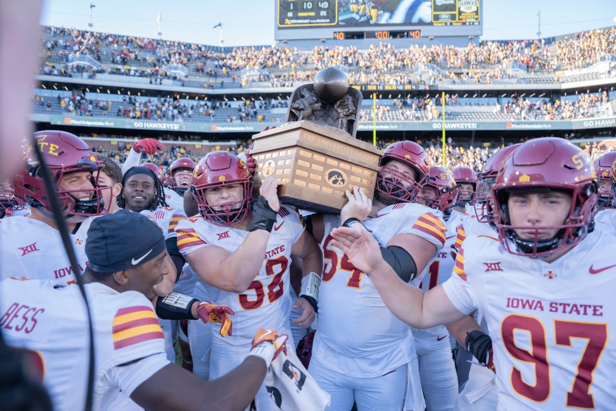 Joey Peterson (52) and Jarrod Hufford (54) take home the Cy-Hawk trophy after Iowa State defeats Iowa 20-19 in the Cy-Hawk game at Kinnick Stadium in Iowa City, Iowa on Sept. 7 2024.