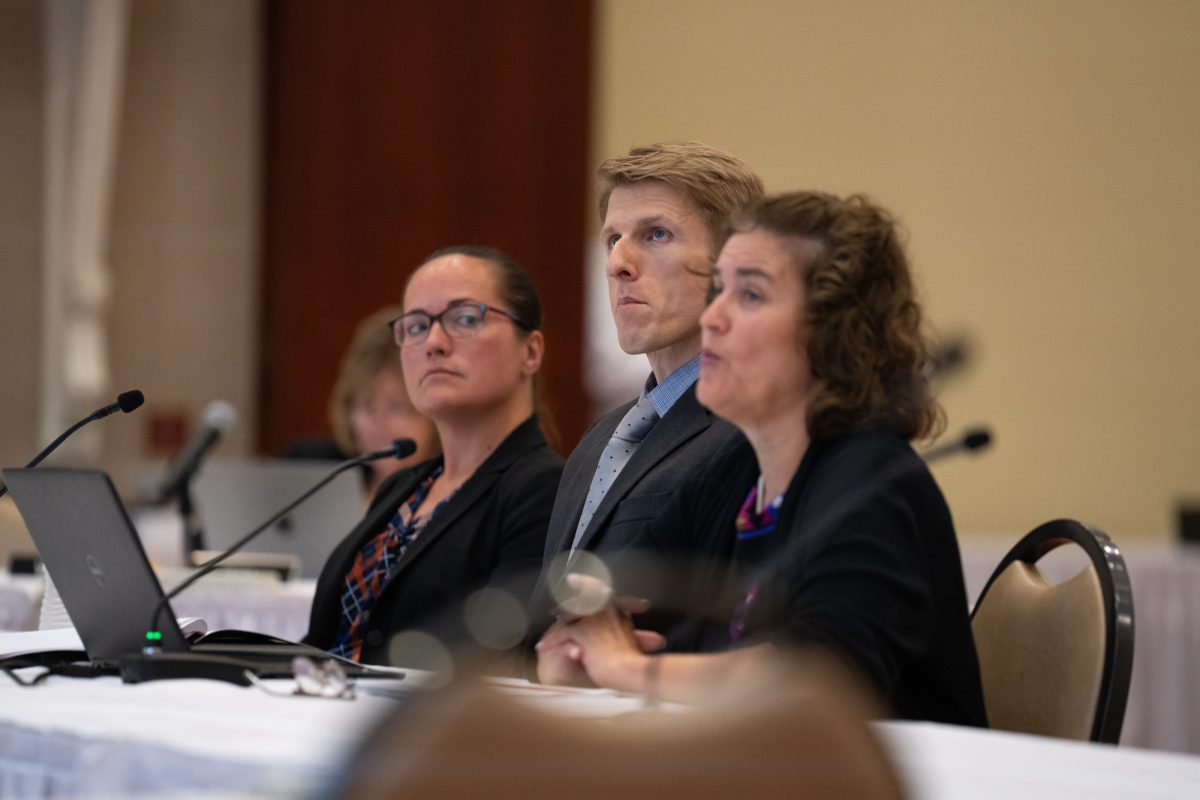 Iowa Board of Regents Board Counsel Aimee Claeys (left) listens after introducing Iowa State's presenters on Sexual Harassment and Discrimination Prevention Training. Associate General Counsel Brett Lohoefener (center) and Equal Opportunity Director and Title IX Coordinator Mary Howell Sirna, at the Alumni Center on Sept. 19, 2024. 
