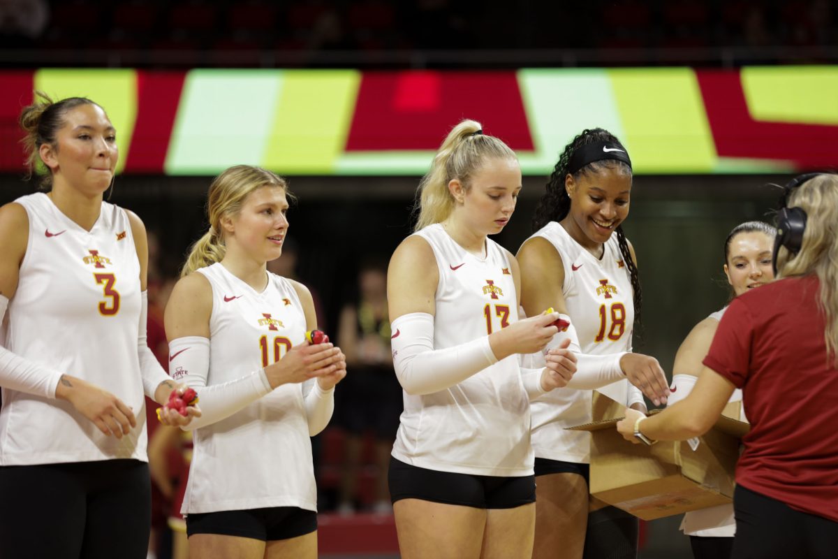 Iowa State players holding a Cy the Cardinal stress toy at the Iowa State vs. Brigham Young University volleyball game at Hilton Coliseum Oct.16, 2024. 