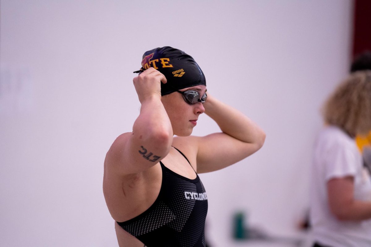 Iowa State swimmer putting on her goggles before her event during the Iowa State vs South Dakota State, Beyer Hall, Oct. 10, 2024.