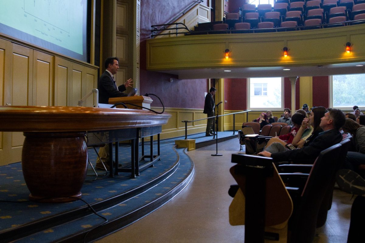 Daniel M. Shea talking about rural-urban voting patterns over time during "The Rural Voter: The Politics of Place and the Disuniting of America" lecture while people watch on at Curtiss Hall, Oct 03, 2024.