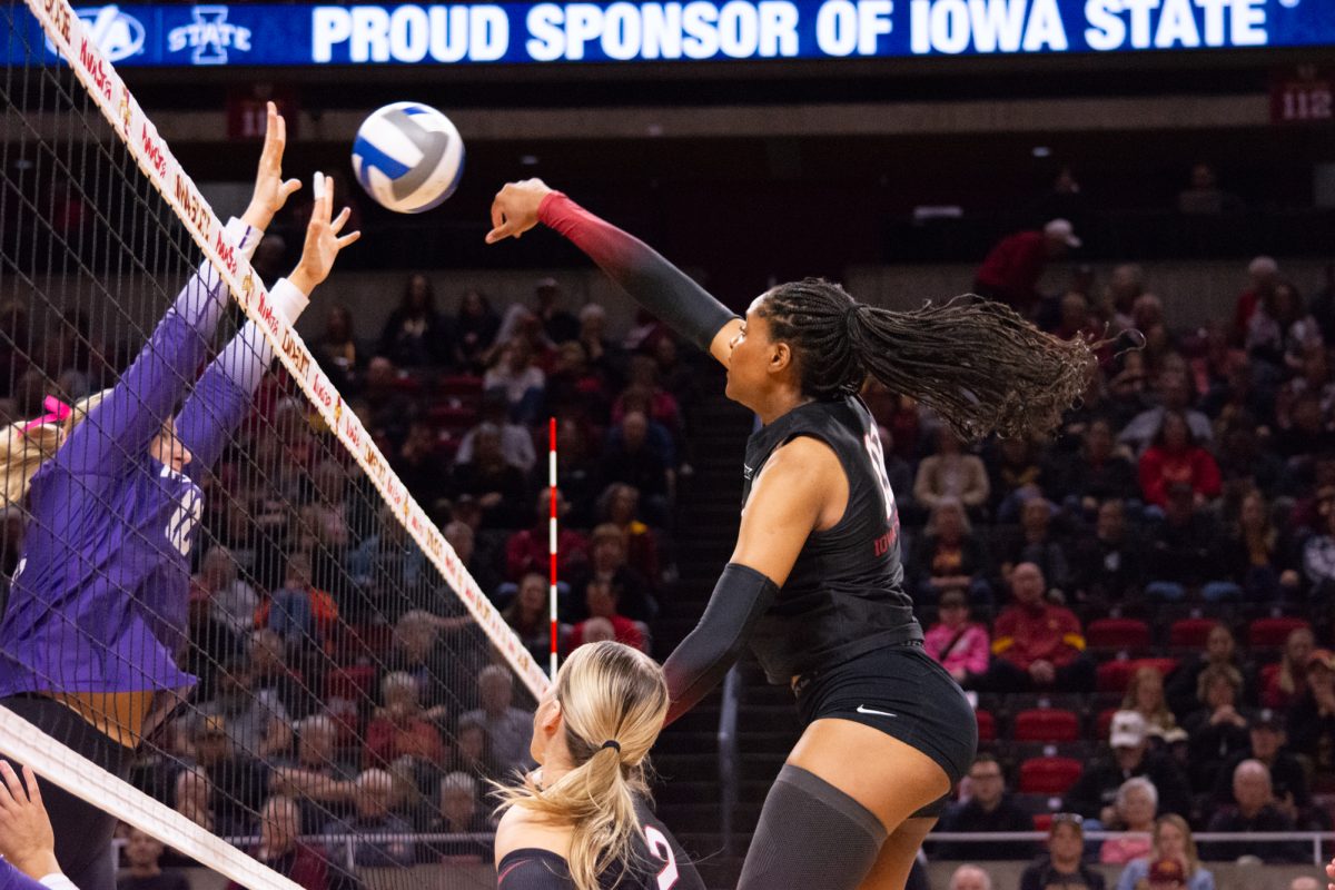 Amiree Hendricks-Walker (18) spikes the ball over the net during the game vs. Kansas State University, Hilton Colosseum, Ames, Iowa, Oct. 27, 2024.