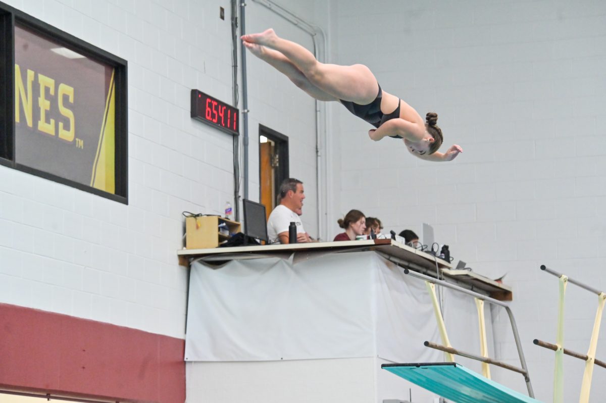 Iowa State Abby Tollefson twist in the air after jumping off of the diving board during home meet against South Dakota, Oct. 18, 2024.