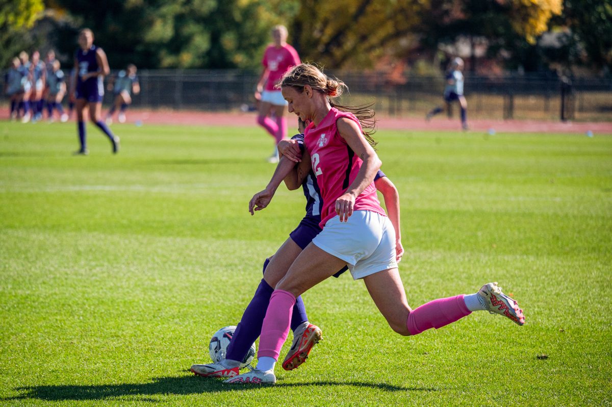 Iowa State player Adelaide Wolfe (22) tries to hold the visiting Texas Christian University player back and take the ball during a home game at the Cyclone Sports Complex, Oct. 20, 2024.