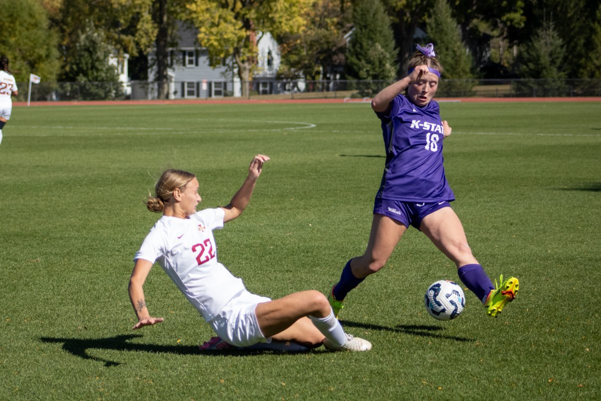 Iowa State's women's soccer player Adelaide Wolfe sliding to kick the ball away from K-State player versus K-State at Cyclone Sports Complex, Oct. 6, 2024. 