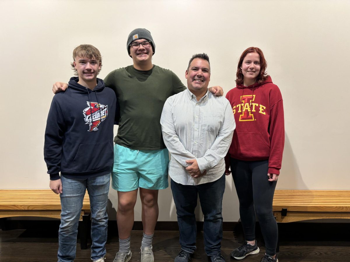 Tate Tromblay (navy hoodie) and Sam Peters (green shirt) pose for a photo with two other members of the UNASA, Fall 2024.