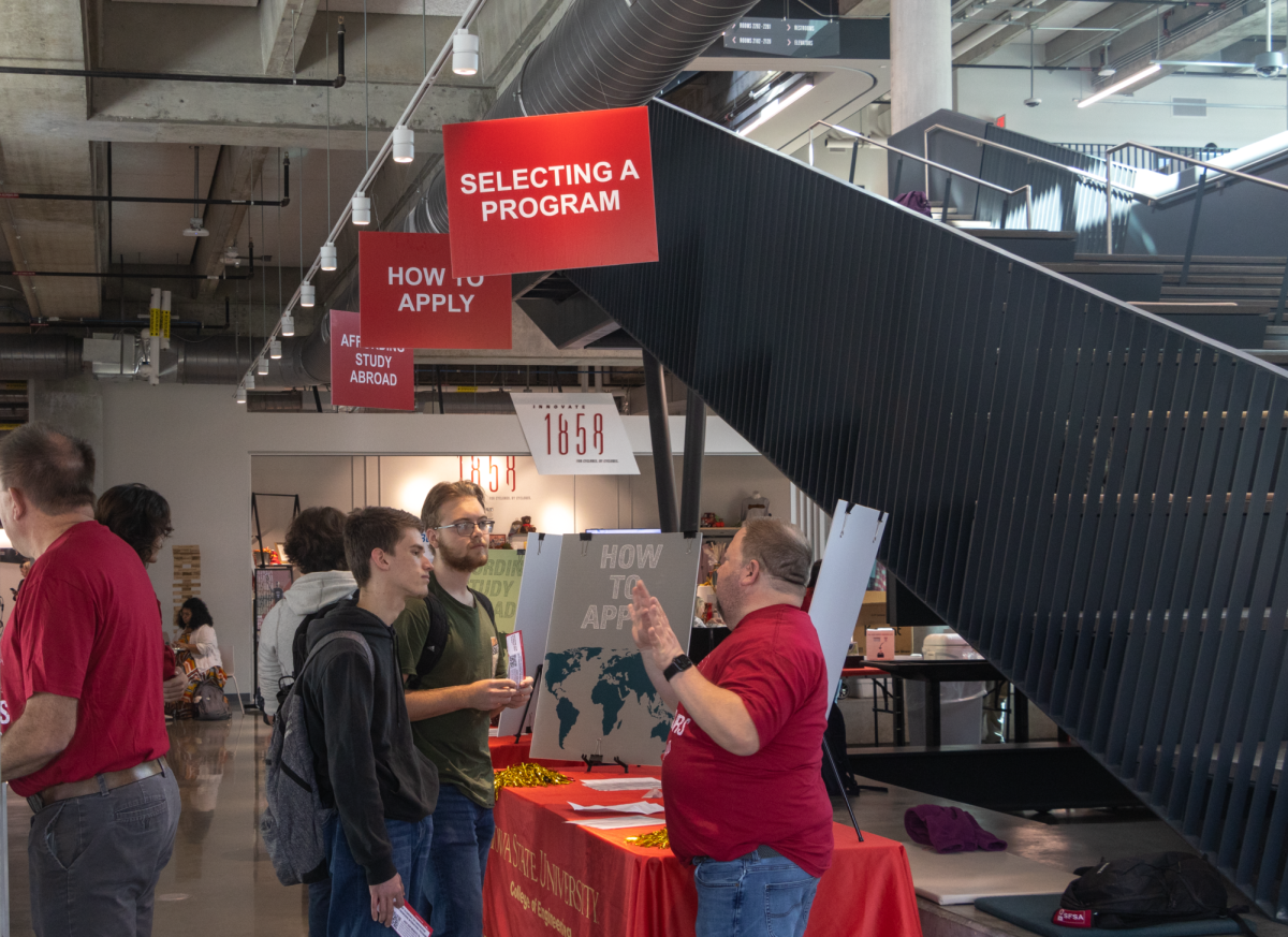 Mauricio Llavona (Left) and Cody Vulich (Middle) learn about studying abroad from Jodi Cornell (Right) at the Engineering Study Abroad Fair, Oct. 9, 2024, Ames, Iowa.