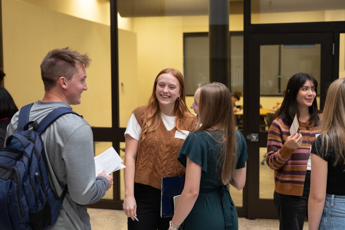 Ava Eisenbarth (Middle), a Junior in Architecture and Rachel Koster (Right), Junior in Architecture share a joke while waiting to talk to employers. October 3rd, 2024