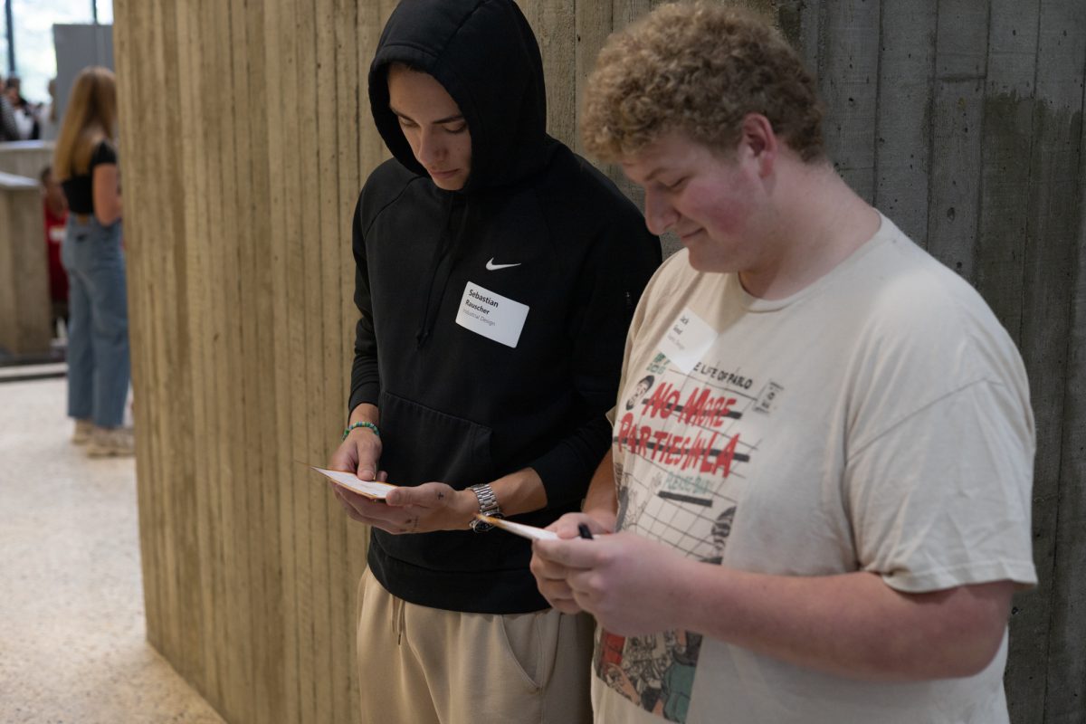 Sebastian Rauscher (Left), a Freshman in Industrial Design, and Jack Good (Right), a Freshman in Graphic Design, check their bingo cards. October 3rd, 2024