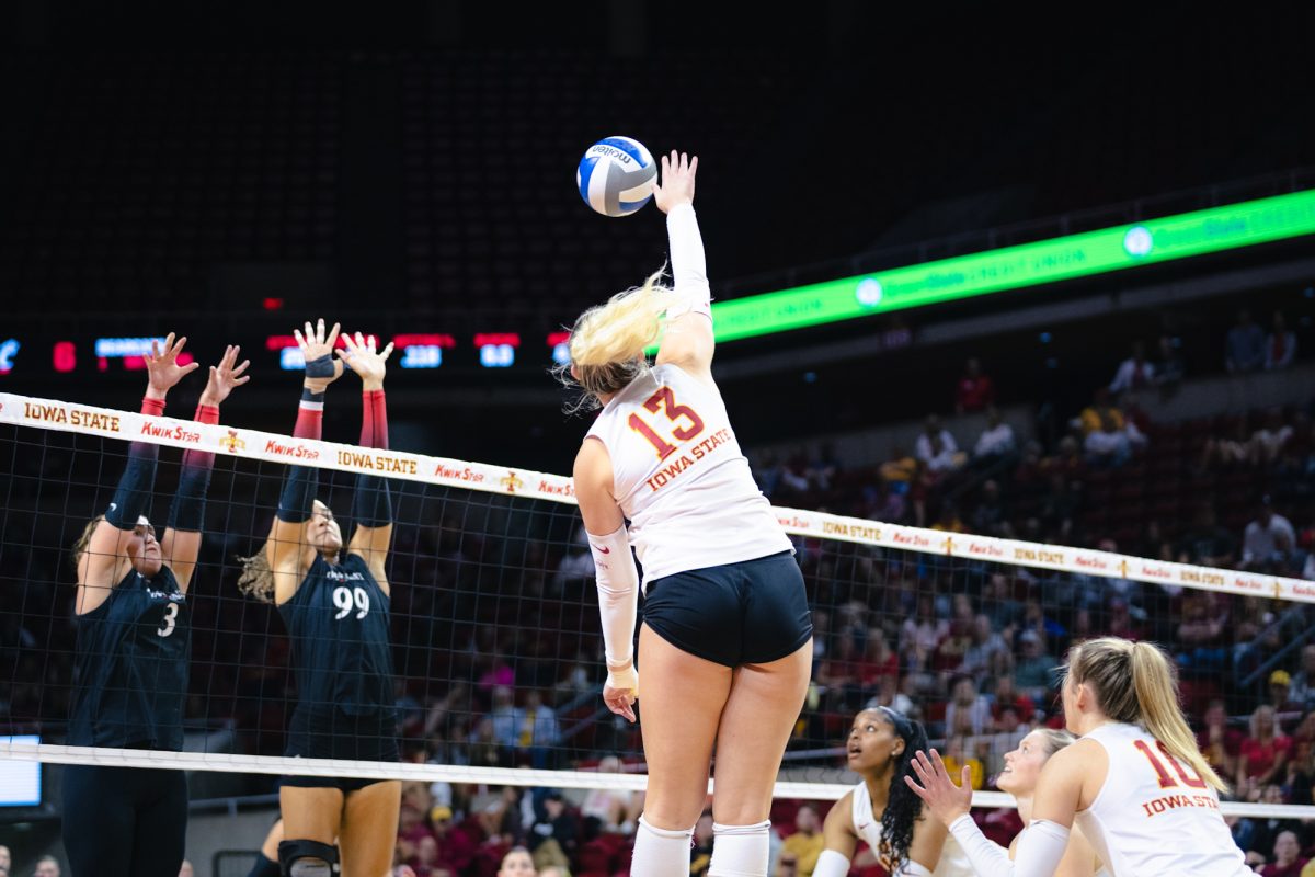 Lilly Wachholz (13) hits the ball during the Iowa State vs Cincinnati volleyball game at Hilton Coliseum on Oct. 2, 2024.