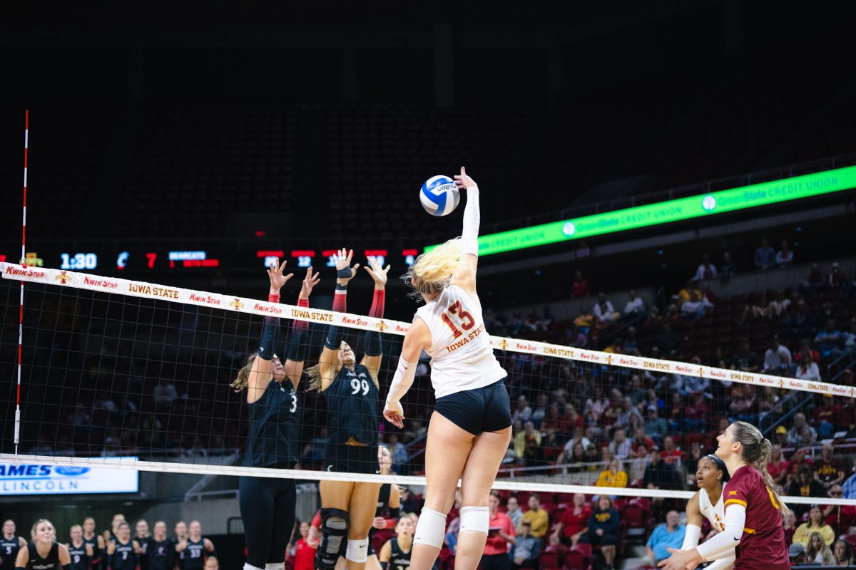 Lilly Wachholz (13) hits the ball during the Iowa State vs Cincinnati volleyball game at Hilton Coliseum on Oct. 2, 2024.