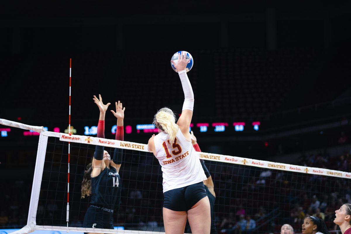 Lilly Wachholz (13) hits the ball during the Iowa State vs Cincinnati volleyball game at Hilton Coliseum on Oct. 2, 2024.