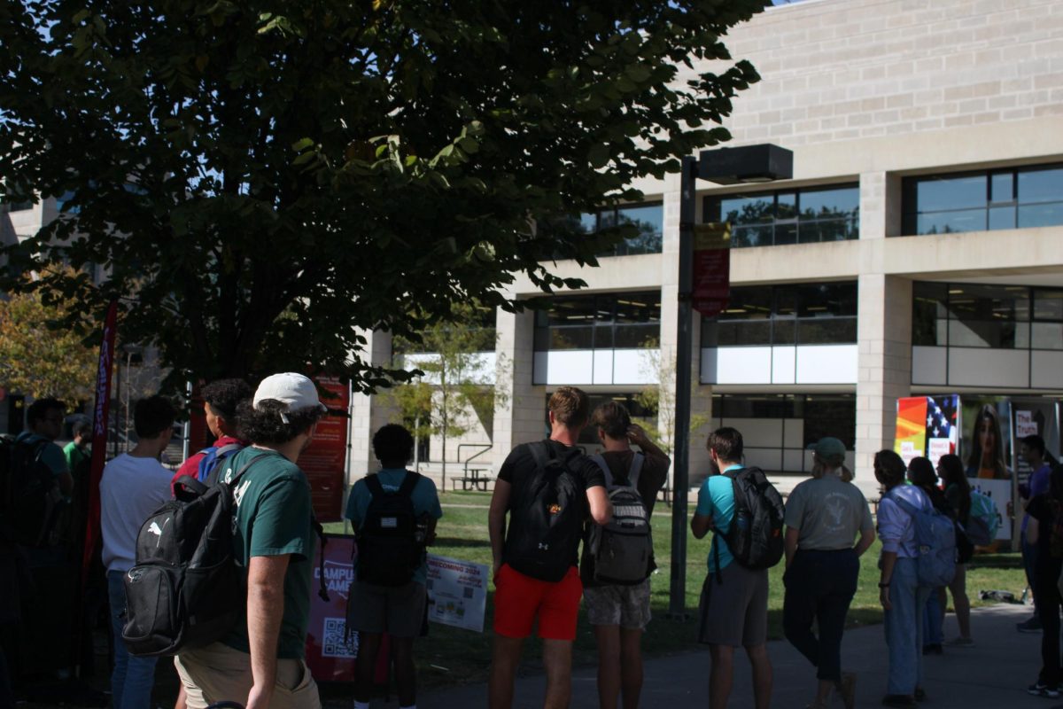 Student on campus gather to listen to preacher Tom Short and others involved in Campus America preach outside the Parks Library, Oct. 9, 2024.