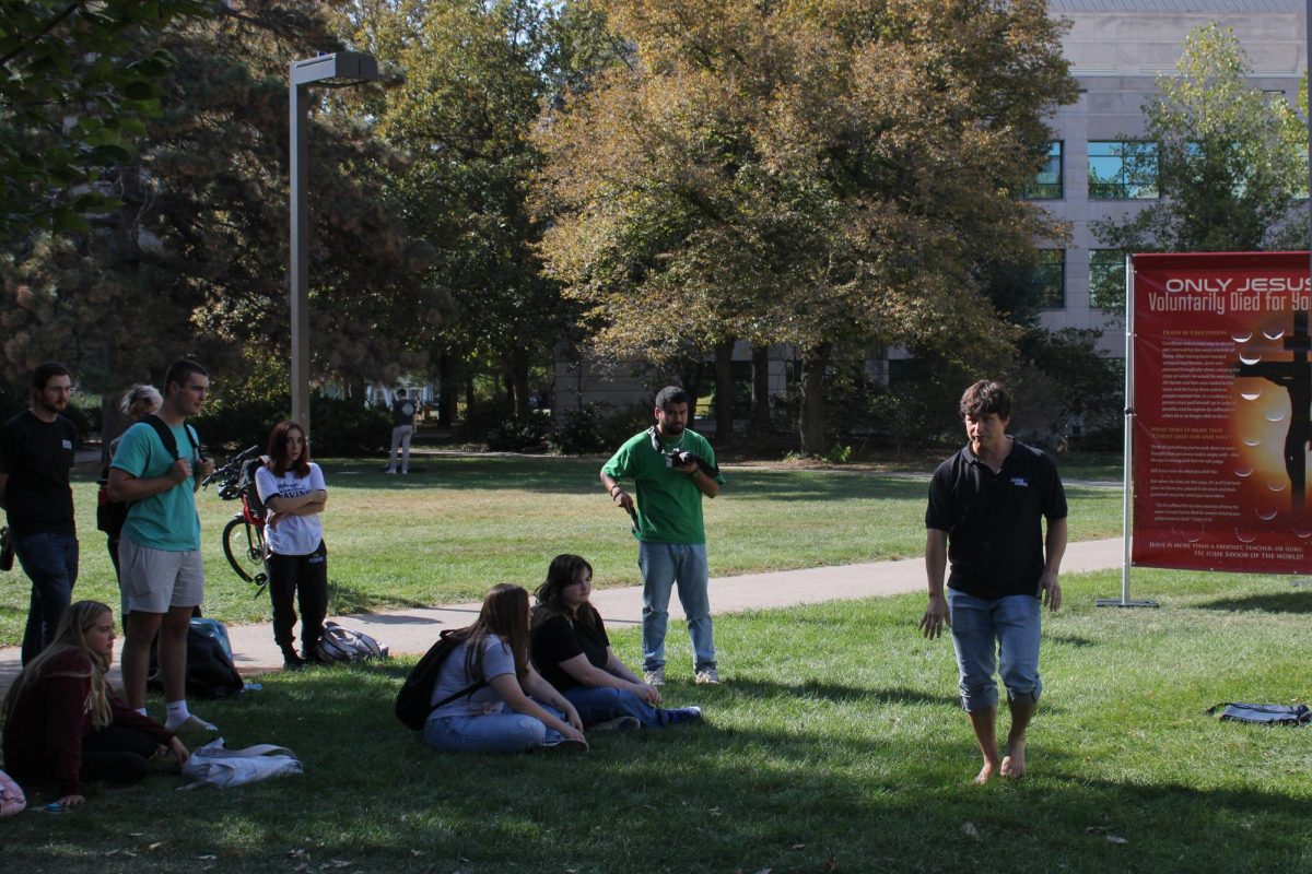 Skylar Sowry, representing Campus America, discusses to groups of college students outside of the Parks Library, Oct. 9, 2024.