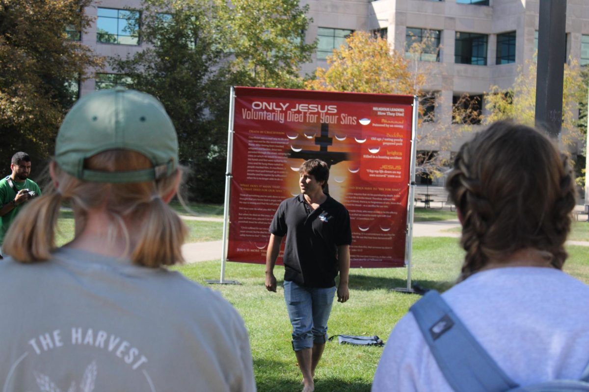 Skylar Sowry, representing Campus America, discusses their ideas outside Parks Library, Oct. 9, 2024.