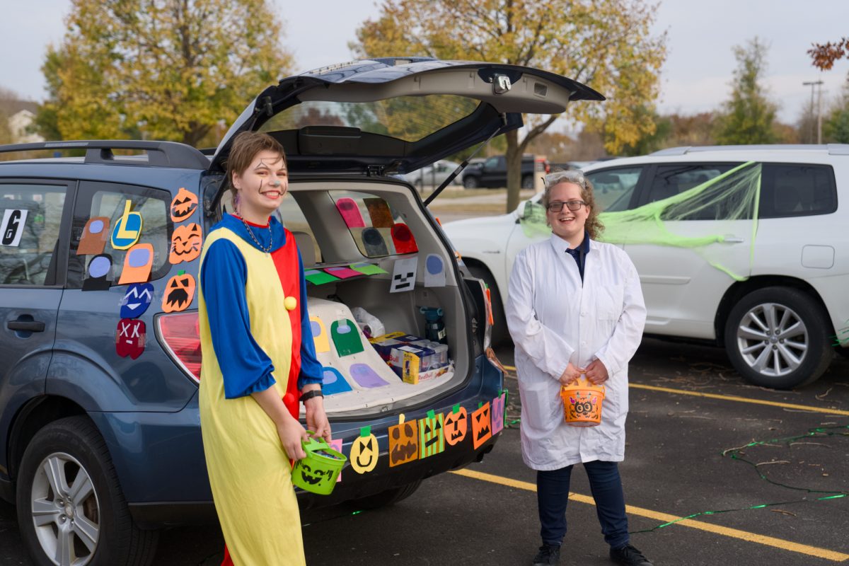 Rylee Foreman (left) and Ena Stojonovic dress up and hand out candy for the Iowa State University Collegiate 4-H Trunk or Treat, near the Extension 4-H Youth Building, Oct. 29, 2024.