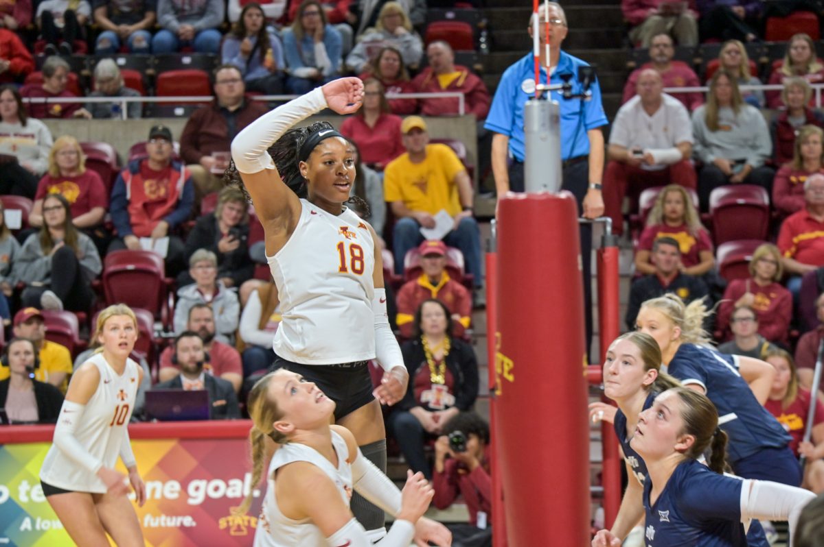 Iowa State Amiree Hendricks-Walker (18) in the air after being ready to block the ball coming from the visiting Brigham Young University in Hilton Coliseum, Oct. 16, 2024.