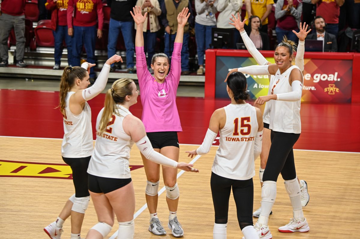 Iowa State women's volleyball players celebrate after gaining a point against the visiting opponent Brigham Young University in Hilton Coliseum, Oct. 16, 2024. 