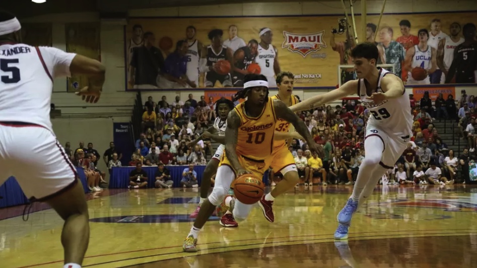 Keshon Gilbert (#10) drives on Dayton defenders at the Lahaina Civic Center on Nov. 26, 2024. 