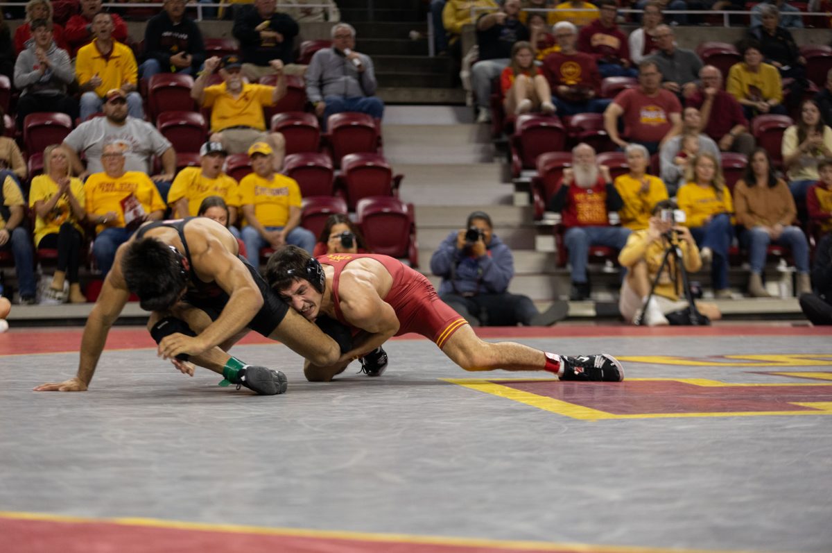 An Iowa State wrestler takes on his opponent at the Iowa State vs. Stanford University wrestling meet at Hilton Coliseum, Ames, Iowa, Nov.8, 2024. 