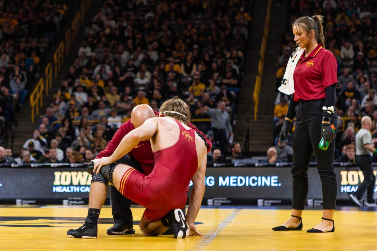 Connor Euton gets medical attention during the Iowa State vs. University of Iowa wrestling match at Carver-Hawkeye Arena on Nov. 23, 2024 in Iowa City, Iowa.