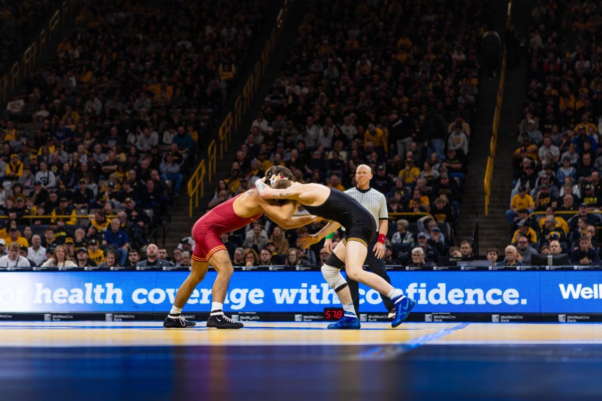 Adrian Meza wrestles #27 Kale Petersen at 125 pounds during the Iowa State vs. University of Iowa wrestling match at Carver-Hawkeye Arena on Nov. 23, 2024 in Iowa City, Iowa.