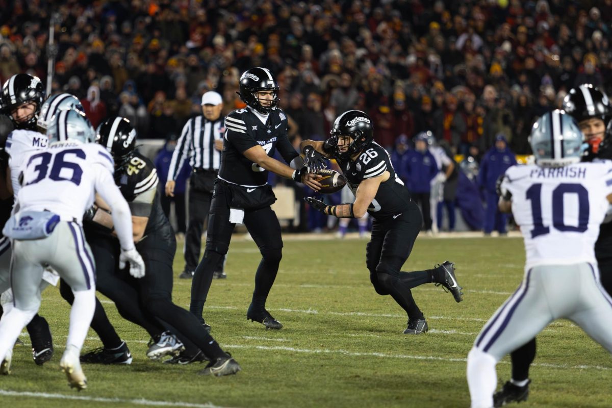 Quarterback Rocco Becht (3) hands off the ball to Running Back Carson Hansen (26) during the Iowa State vs. Kansas State University football game at Jack Trice Stadium on Nov. 30, 2024 in Ames, Iowa.