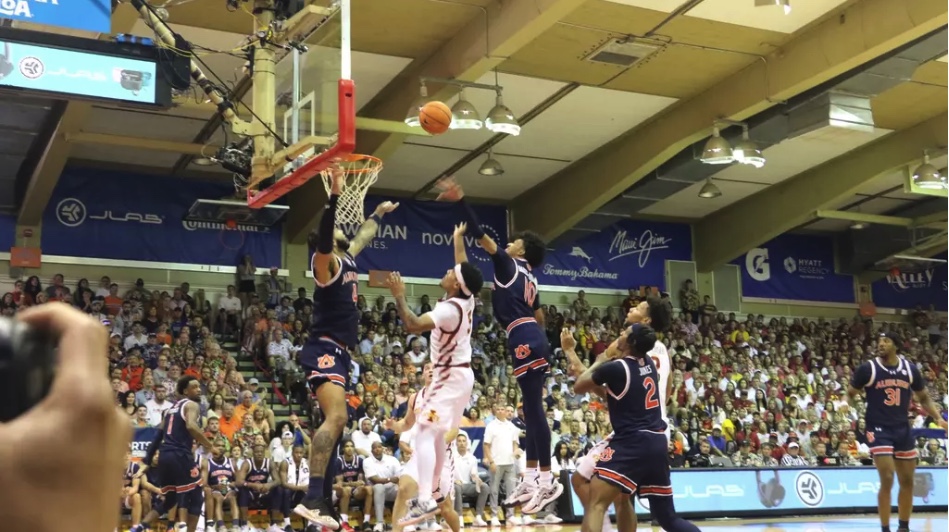 Tamin Lipsey (#3) attempts a shot over Auburn defenders at the Lahaina Civic Center on Nov. 25, 2024. 