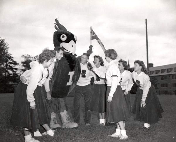 The Iowa State cheer squad introduced the original Cy during the 1954 Homecoming football game. Collegiate Manufacturing designed and built the new mascot with input from the Pep Council and the cheerleading squad.  The cost was $200.  The eight foot bird was introduced at Homecoming, October 16, 1954. Historic images courtesy of Special Collections and University Archives.