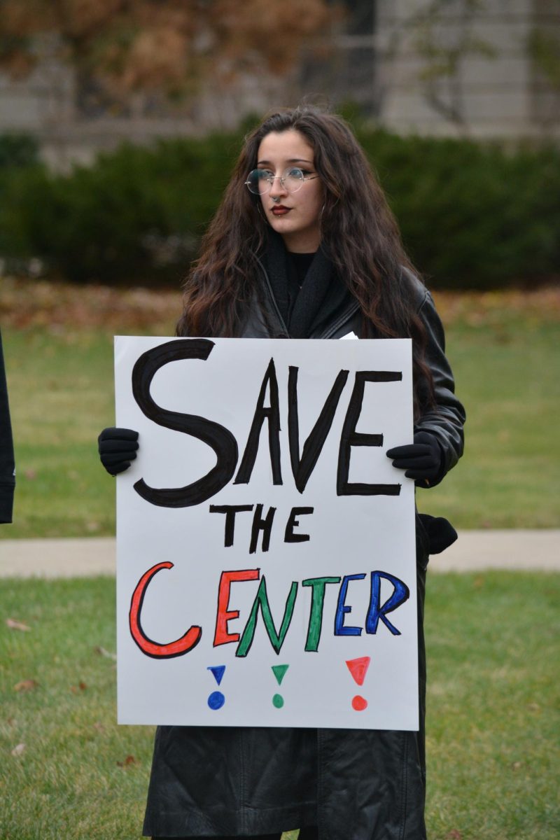 Graciela Rangel holds a sign reading “Save the Center” at a protest against anti-DEI legislation outside Parks Library, Iowa State University, Ames, Iowa, Nov. 20, 2024.