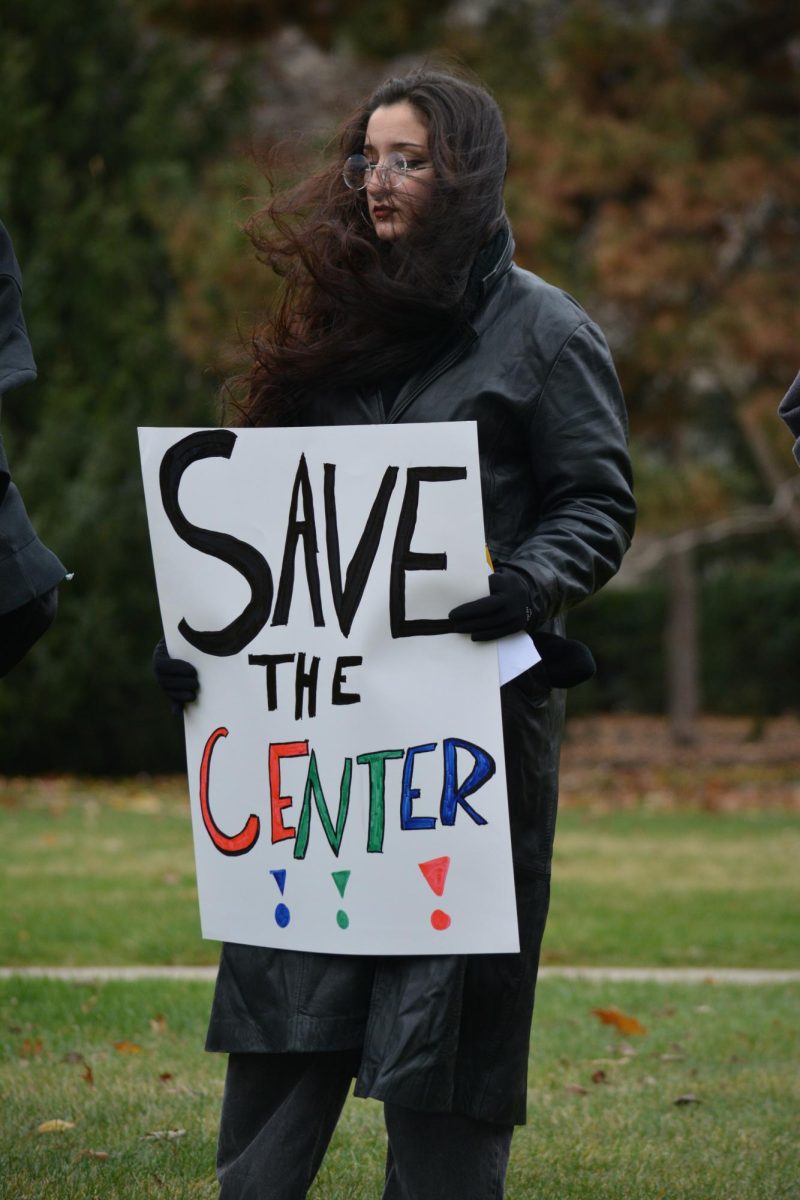 Graciela Rangel holds a sign reading “Save the Center” at a protest against anti-DEI legislation outside Parks Library, Iowa State University, Ames, Iowa, Nov. 20, 2024.