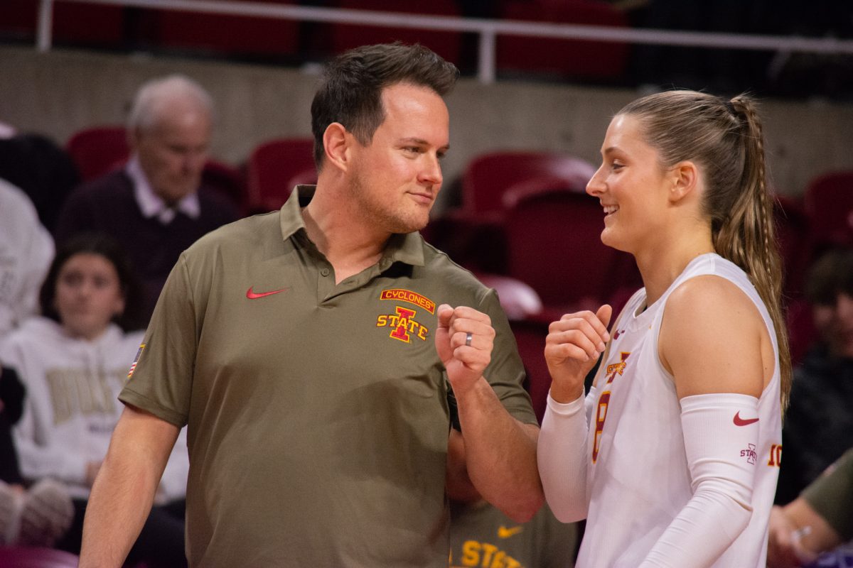 Brooke Stonestreet (8) talks with Assistant Coach Marc Neef in between sets during the game vs. University of Colorado, Hilton Coliseum, Ames, Iowa, Nov. 13, 2024.