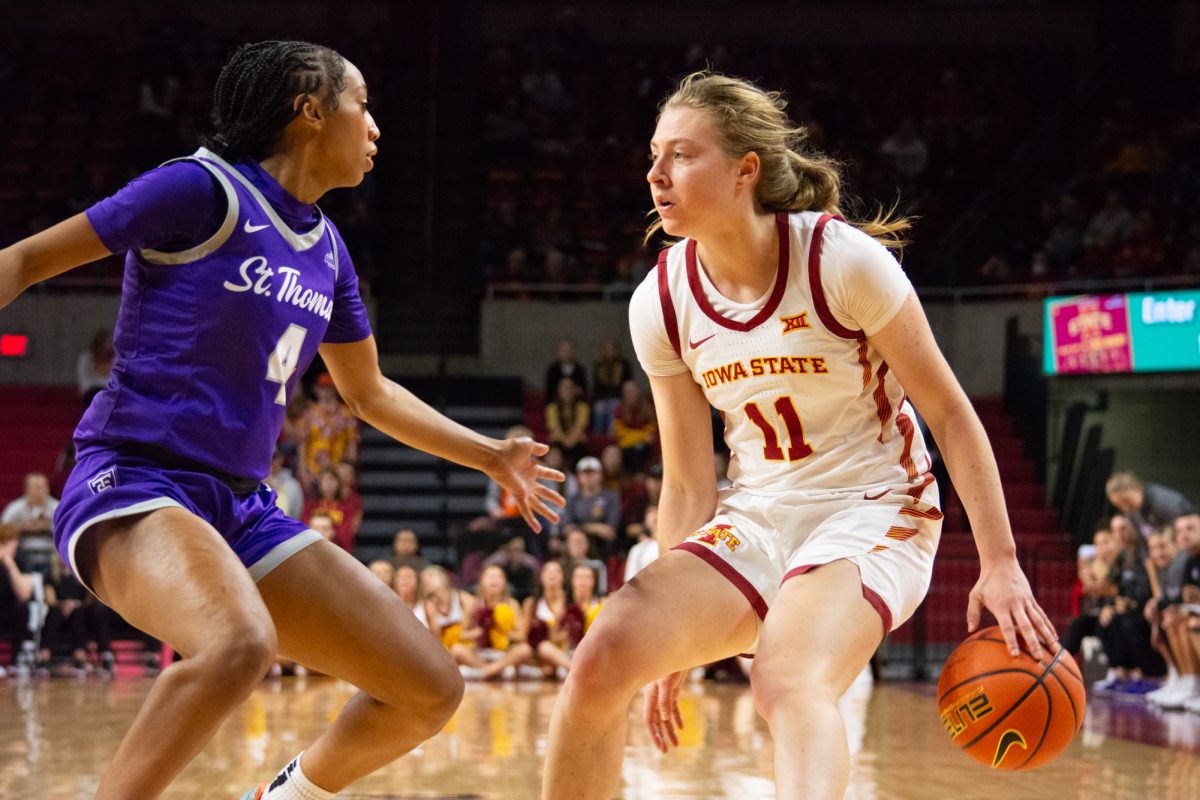 Emily Ryan dribbles the ball while being guarded by Jade Hill (4) during the game vs. University of St. Thomas, Hilton Coliseum, Ames, Iowa, Nov. 14, 2024.