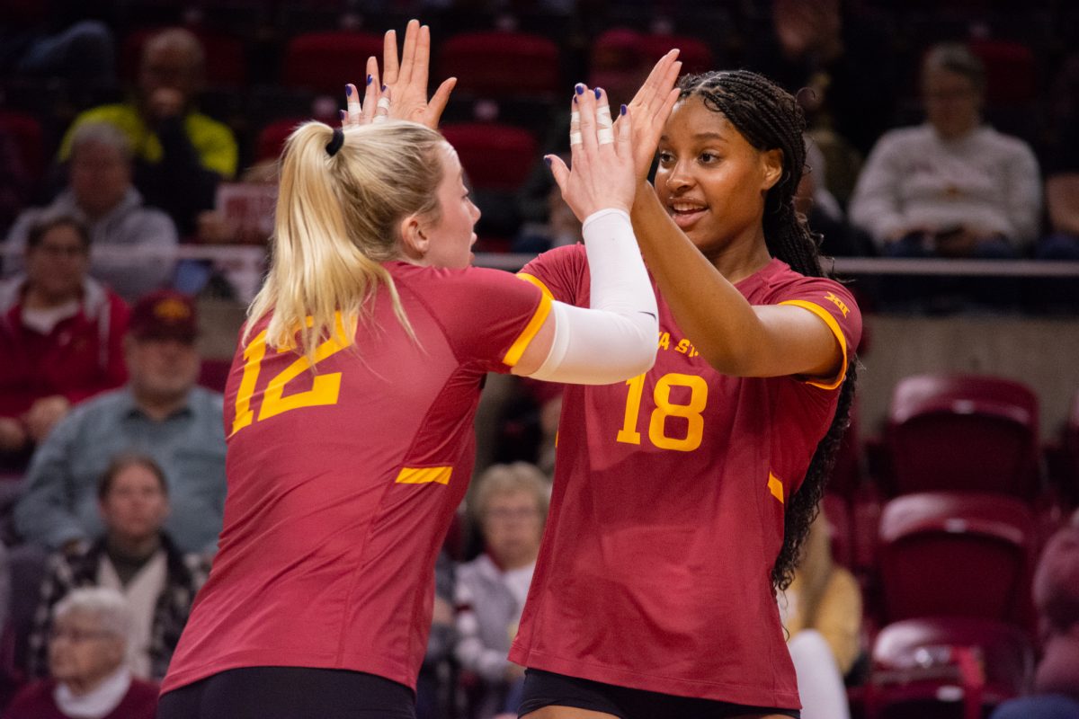 Emily Bobbitt (12) and Amiree Hendricks-Walker (18) celebrate scoring a point during the game vs. University of Colorado, Hilton Coliseum, Ames, Iowa, Nov. 13, 2024.