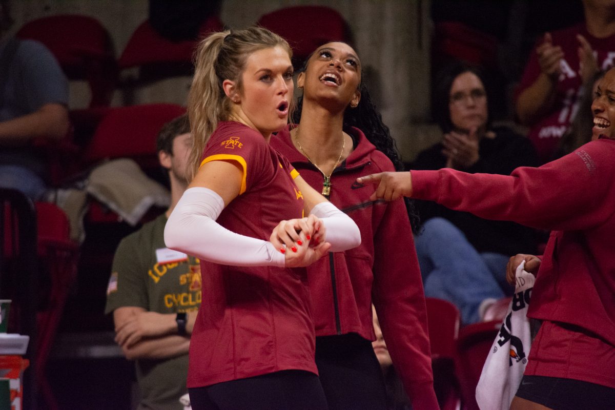 Faith DeRonde (19) celebrates her teammates scoring a point by flexing from the sideline during the game vs. University of Colorado, Hilton Coliseum, Ames, Iowa, Nov. 13, 2024.