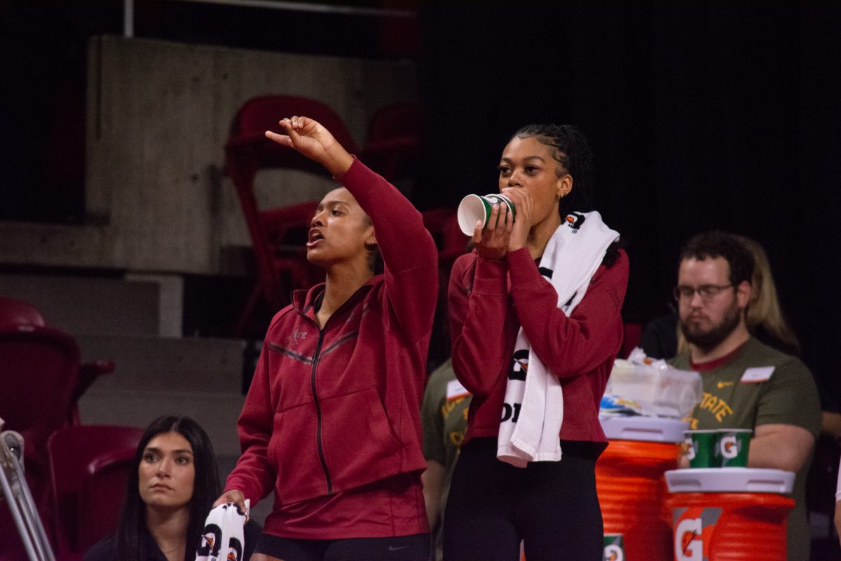 Maya Duckworth (5) cheers from the sideline while Pam McCune (1) yells through a home-made megaphone during the game vs. University of Colorado, Hilton Coliseum, Ames, Iowa, Nov. 13, 2024.