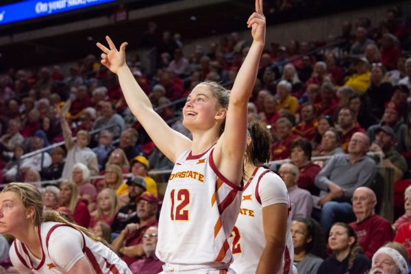 Kenzie Hare (12) celebrates a teammate scoring a point from the sideline during the game vs. Southern University, Hilton Coliseum, Ames, Iowa, Nov. 10, 2024.