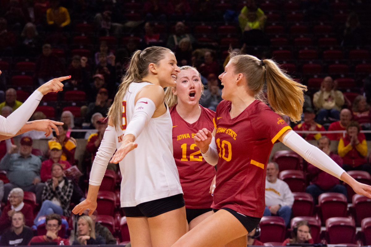 Brooke Stonestreet (8), Emily Bobbitt (12), and Rachel Van Gorp (10) celebrate scoring a point during the game vs. University of Colorado, Hilton Coliseum, Ames, Iowa, Nov. 13, 2024.