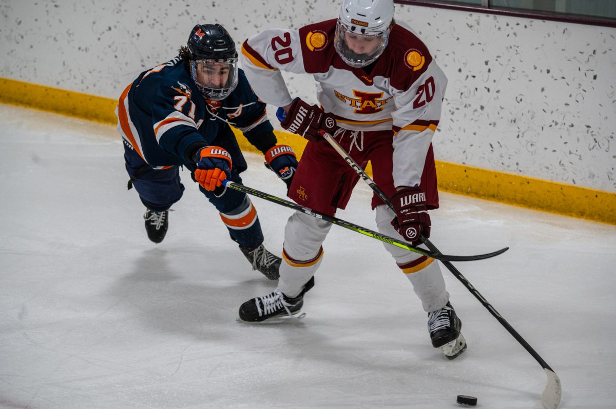 Iowa State player Ben Pfannenstein (20) tries to get the pick to a teammate before the visiting Midland University play could get his stick on it at the Ames Ice Arena, Nov. 1, 2024.