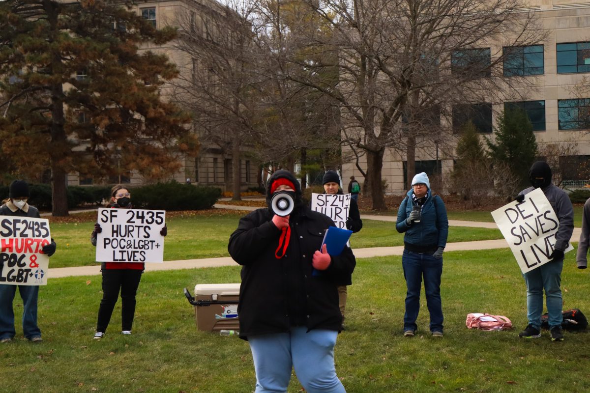 Skylxr Manna leads chants rallying their fellow protesters for DEI support, taken on November 11, 2024 outside Park Library, Ames, IA