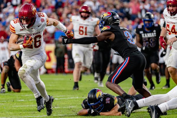 Iowa State RB Carson Hansen (26) takes the ball past University of Kansas players Mello Dotson (3) and Jayson Gilliom (10) for an Iowa State touchdown, Nov. 9, 2024, GEHA Field at Arrowhead Stadium.