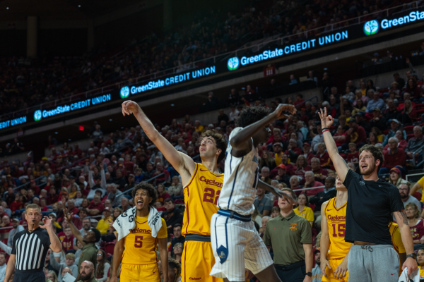 Curtis Jones (5) and Conrad Hawley celebrate a three pointer shot by Milan Momcilovic (22) over a Kansas City defender, Ames, Iowa, Nov. 11, 2024.