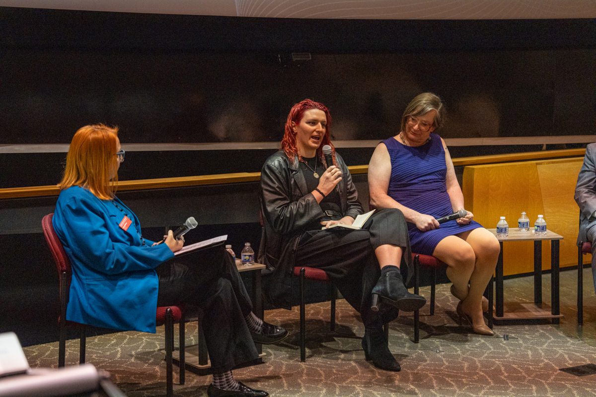 Iowa State Dr. Kelly Winfrey (left) asks Lia Thomas (middle) an athlete and advocate on the panel for a Trans Athletes and the Future of Sports discussion lecture a question that was sent in by the audience at Howe Hall, Nov. 13, 2024.